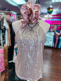 Sequined dress on a mannequin with a large bow in a store setting